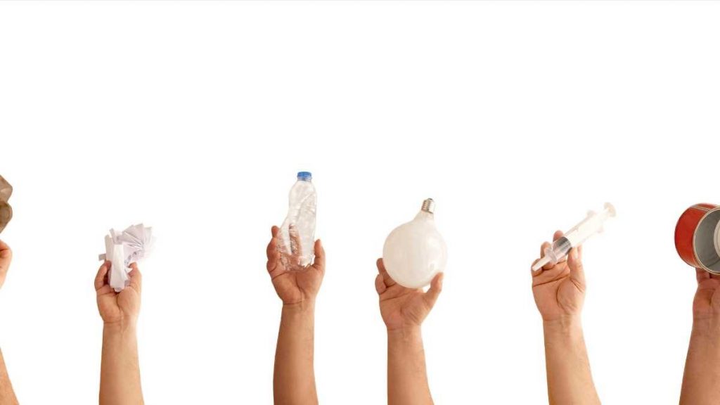 hands in the air with products to recycle