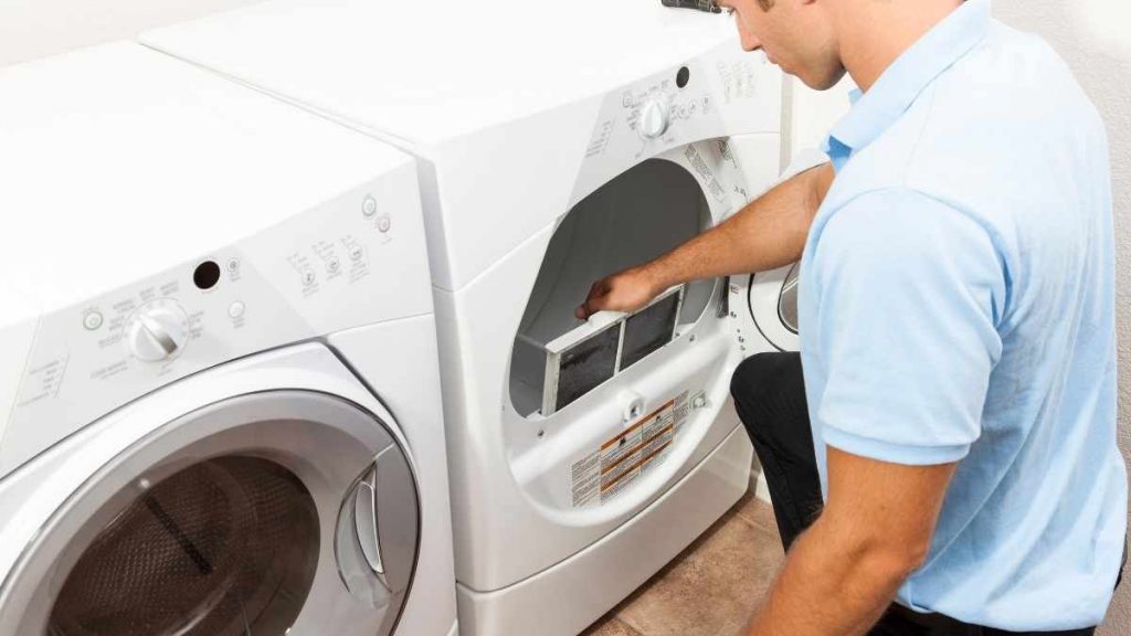 man cleaning clothes dryer
