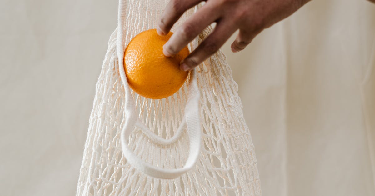 person-holding-white-tote-bag